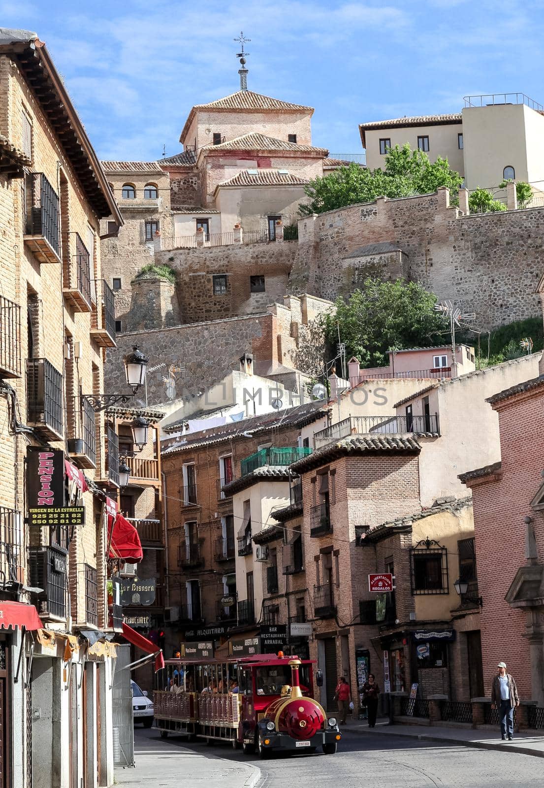 TOLEDO, SPAIN - MAY 06, 2015 - Tourist train on a street of Toledo