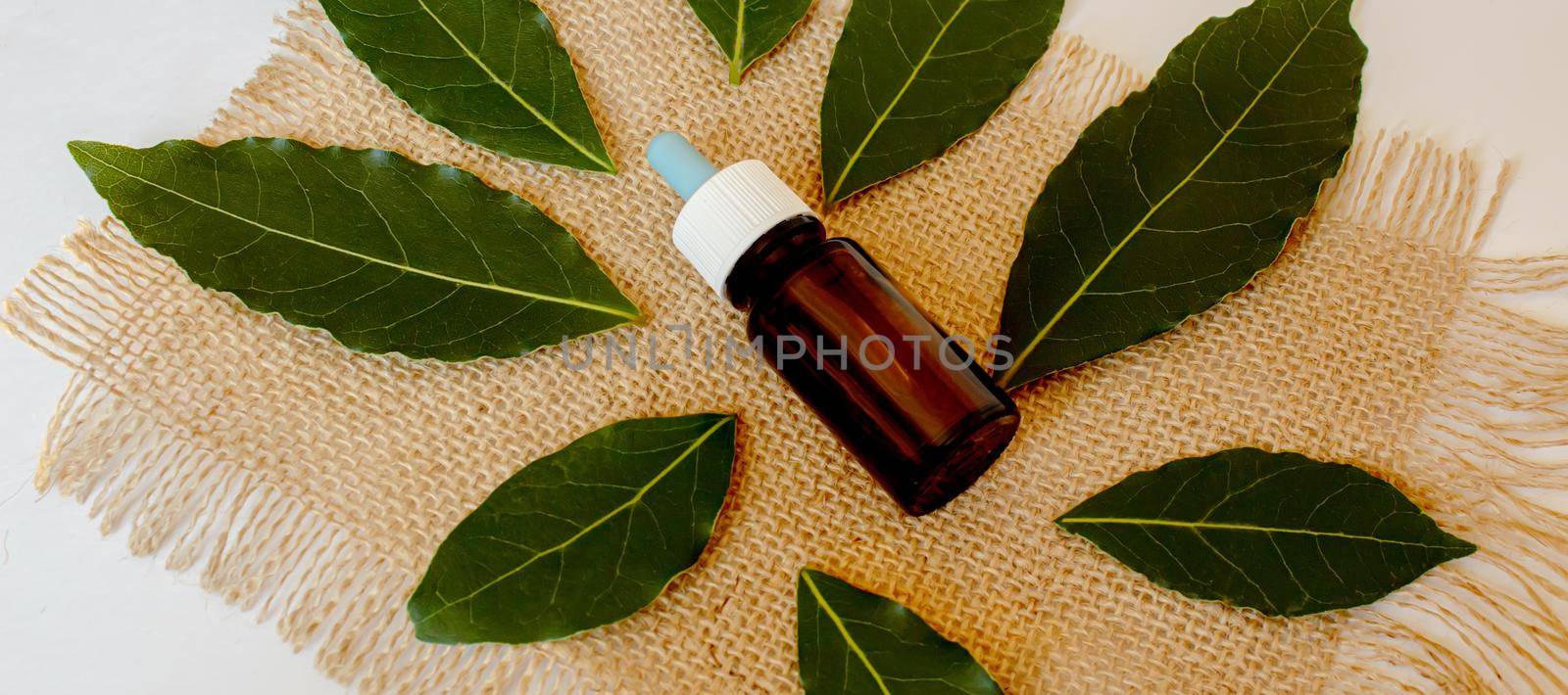 Tea tree essential oil in a small bottle. Selective focus.