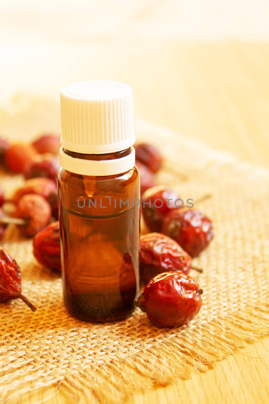 Rosehip seed essential oil in a small bottle. Selective focus.Na
