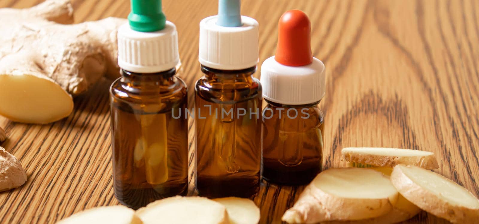 Ginger essential oil in a small bottle. Selective focus.nature