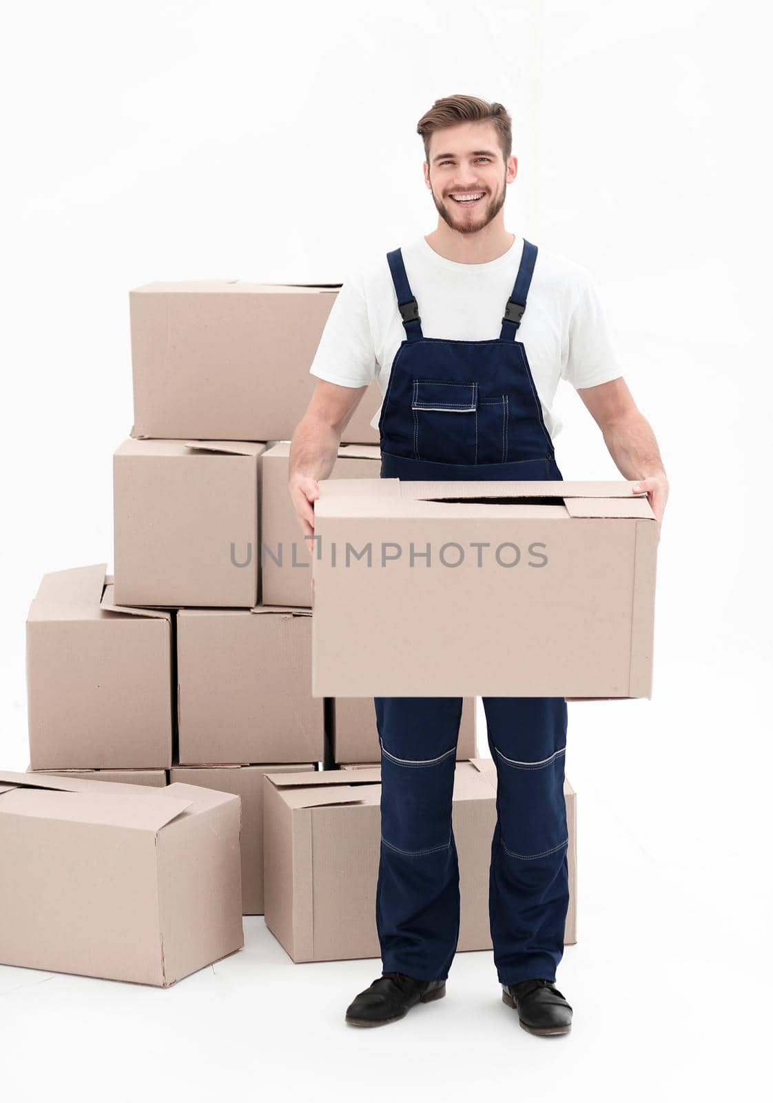 Young man carrying a box to the pile of boxes. by asdf