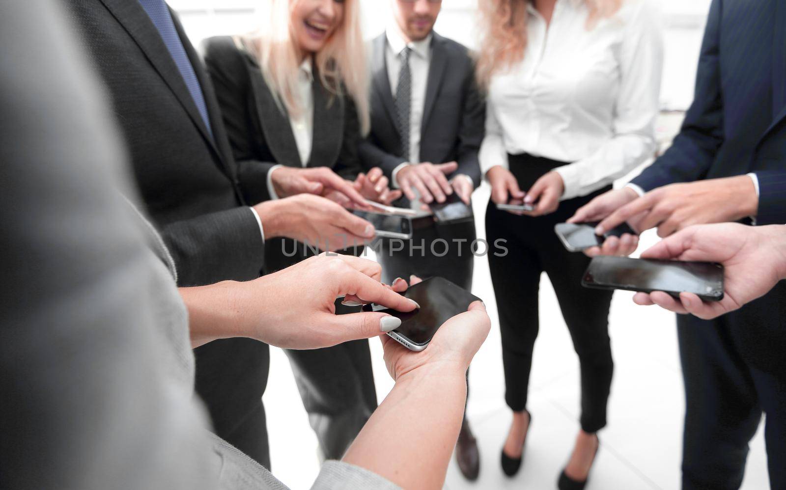 close-up of smartphones in the hands of business youth.people and technology