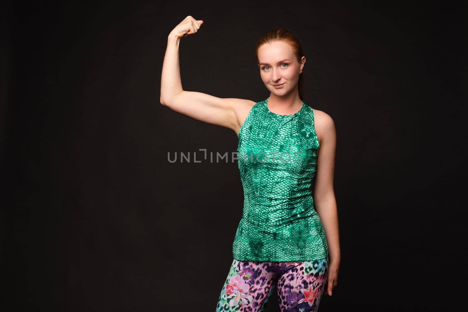 Fit woman in sportswear showing biceps. sport by StudioLucky