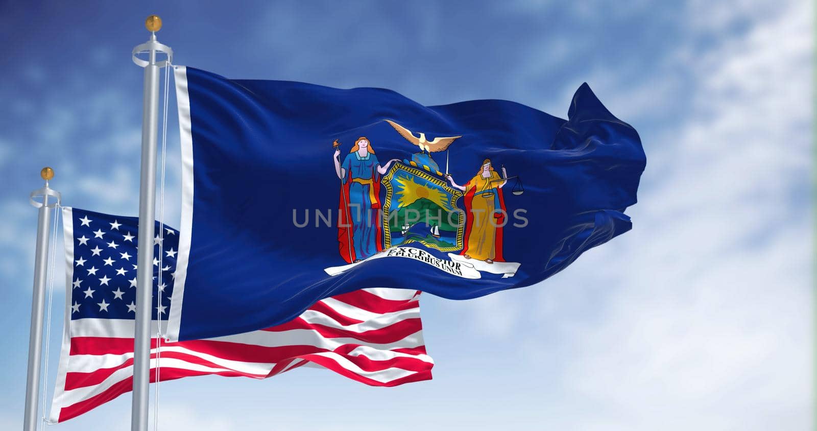 The New York state flag waving along with the national flag of the United States of America. In the background there is a clear sky. New York is a state in the Northeastern United States