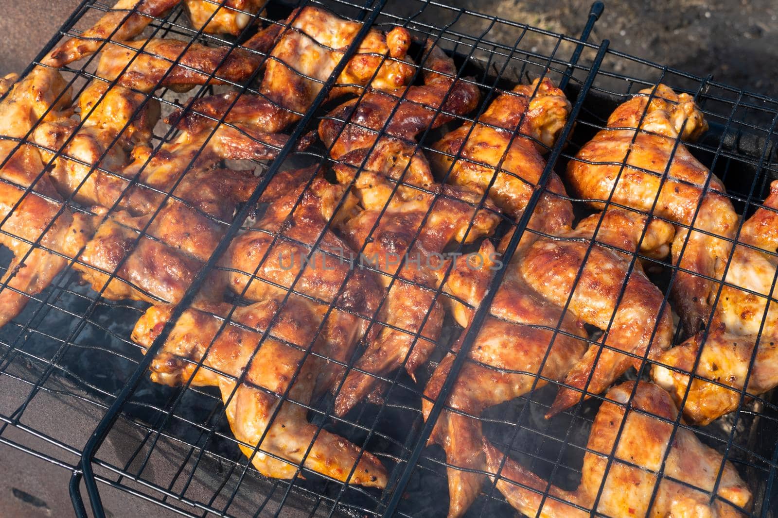 Grilled chicken wings.video 4K cooking fry shish kebab,BBQ, barbecue, shashlik or meat on coals. Cooking meat in the grill on skewers in nature in the summer on a picnic. Pork on the grill