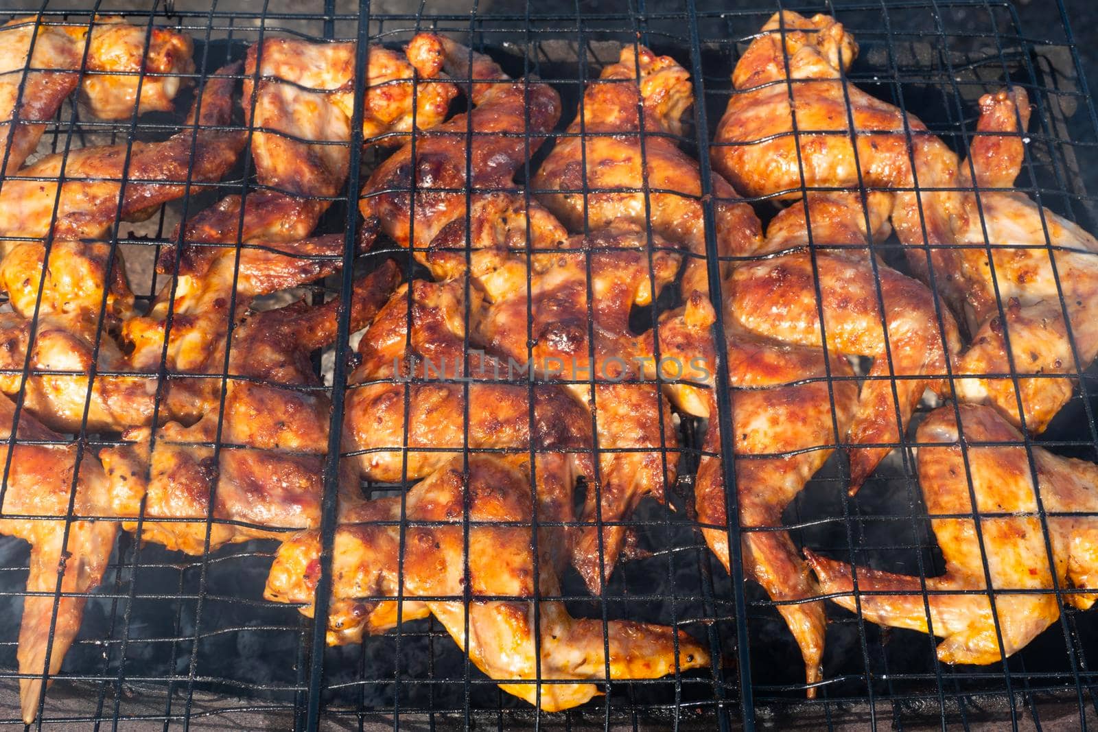 Grilled chicken wings.video 4K cooking fry shish kebab,BBQ, barbecue, shashlik or meat on coals. Cooking meat in the grill on skewers in nature in the summer on a picnic. Pork on the grill