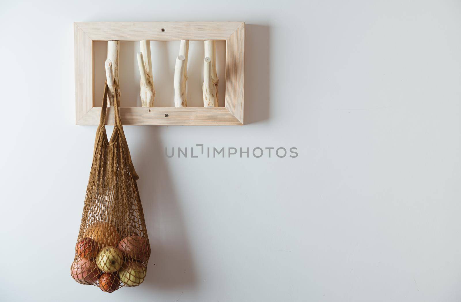 straw bag on handmade wooden hang. Concept of slowlife home. High quality photo