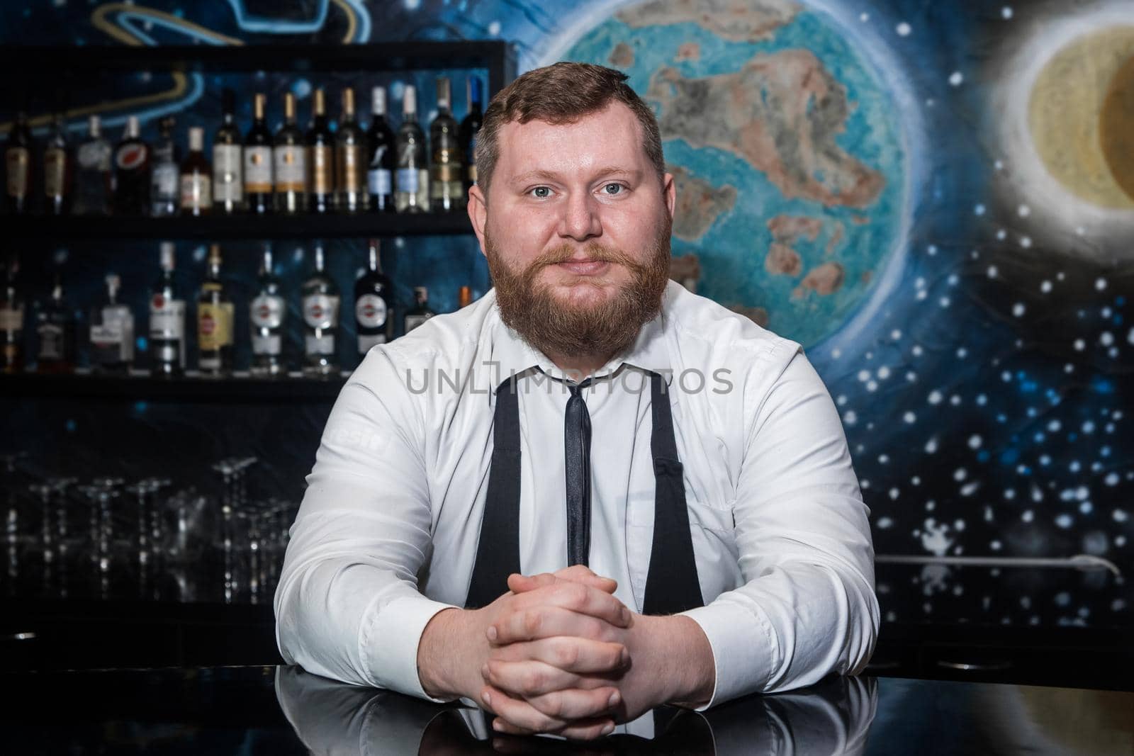 Bearded Adult Caucasian Looking Professional Bartender Portrait in Nightclub.