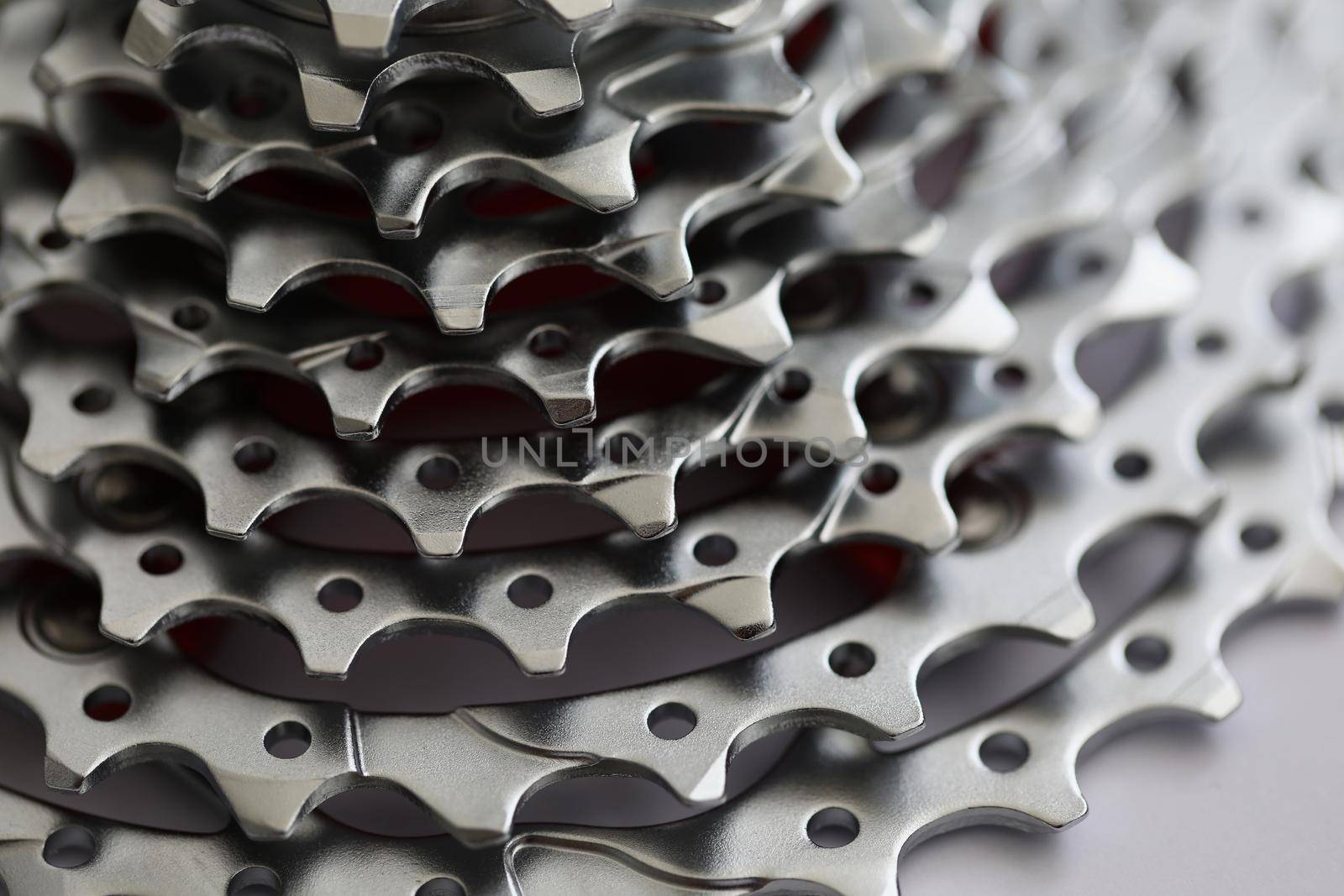 Close-up of bicycle roller chain, part of vehicle that transfer power from pedals to drive. Rear cassette in mountain bike, metal detail. Transport concept