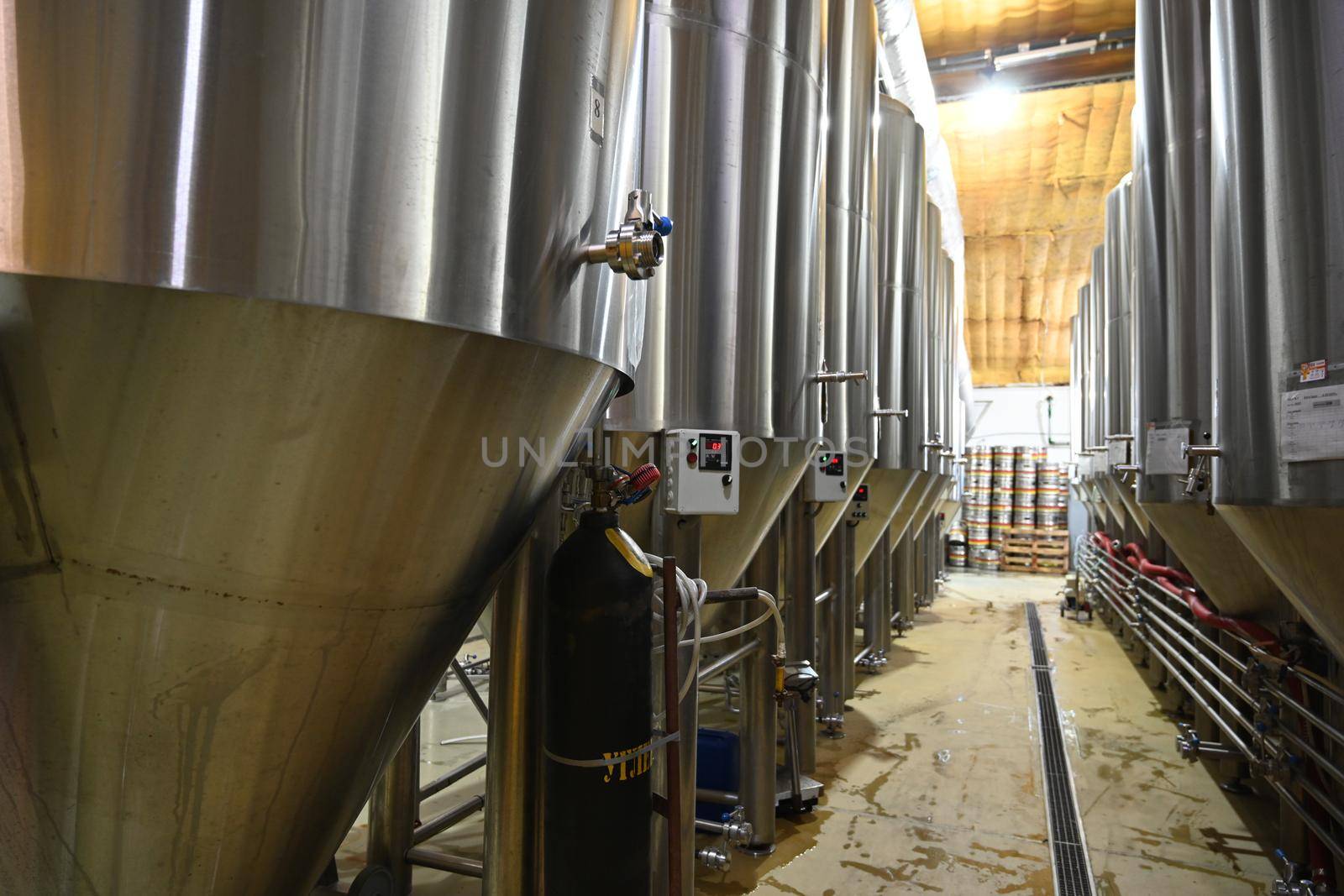 Brewery plant interior. Fermentation mash vats or boiler tanks in a brewery factory.