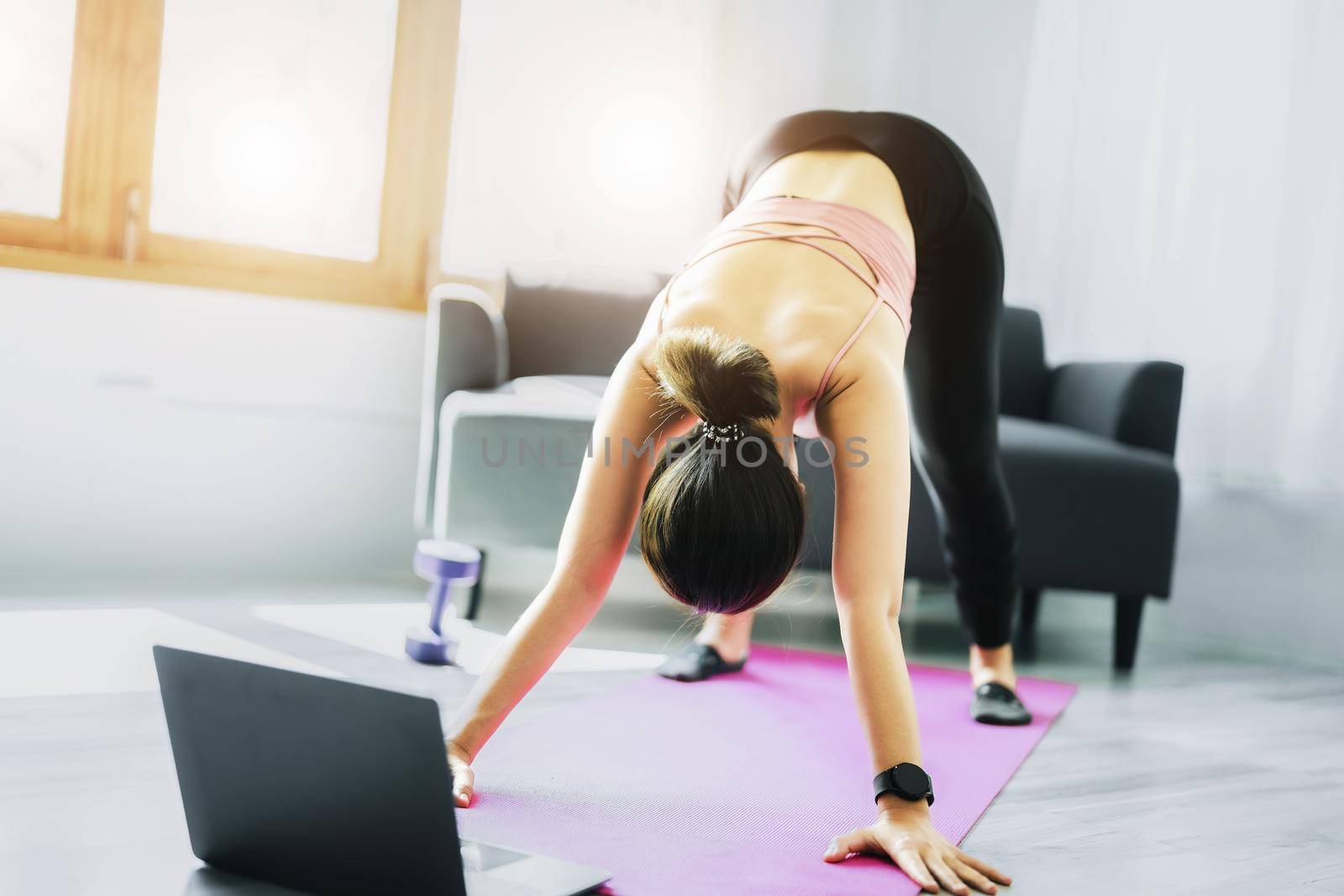 stress relief, muscle relaxation, breathing exercises, exercise, meditation, portrait of Young Asian woman relaxing her body from office work by practicing yoga by watching online tutorials. by Manastrong