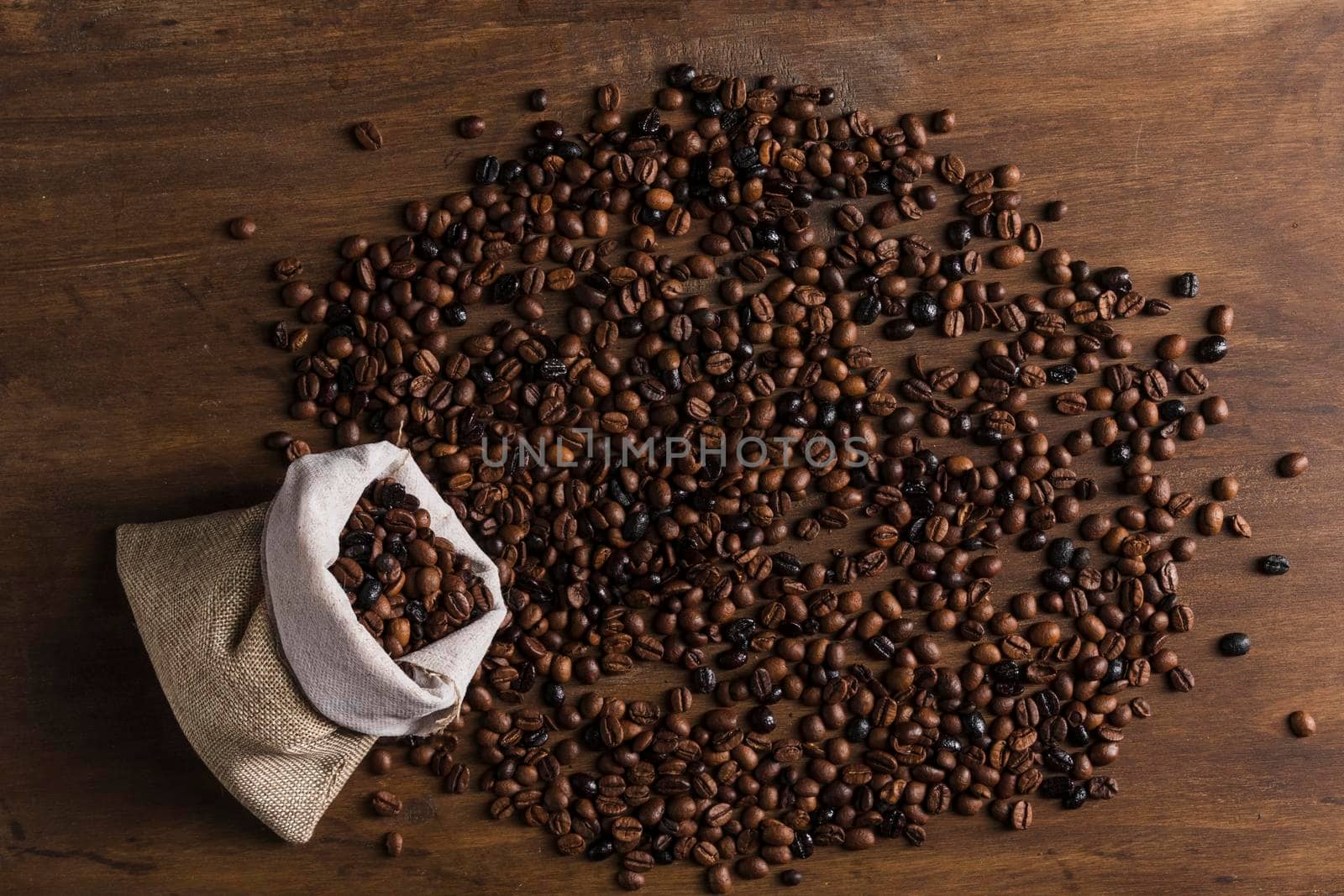 sack with scattered coffee beans by Zahard