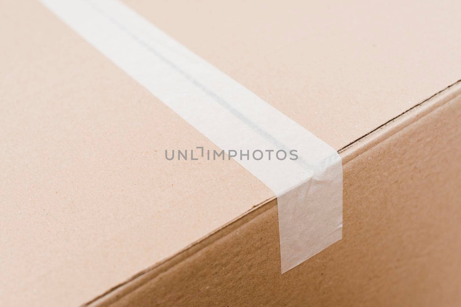 overhead view cardboard box sealed with white packing tape by Zahard