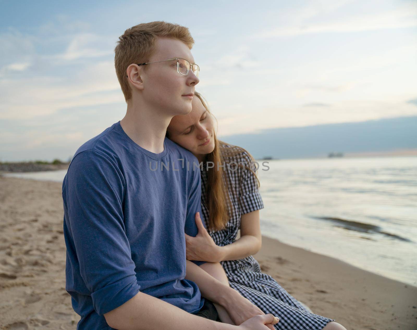 Girl and Boy sitting, girlfriend hold boyfriend hand, concept of teen love by NataBene