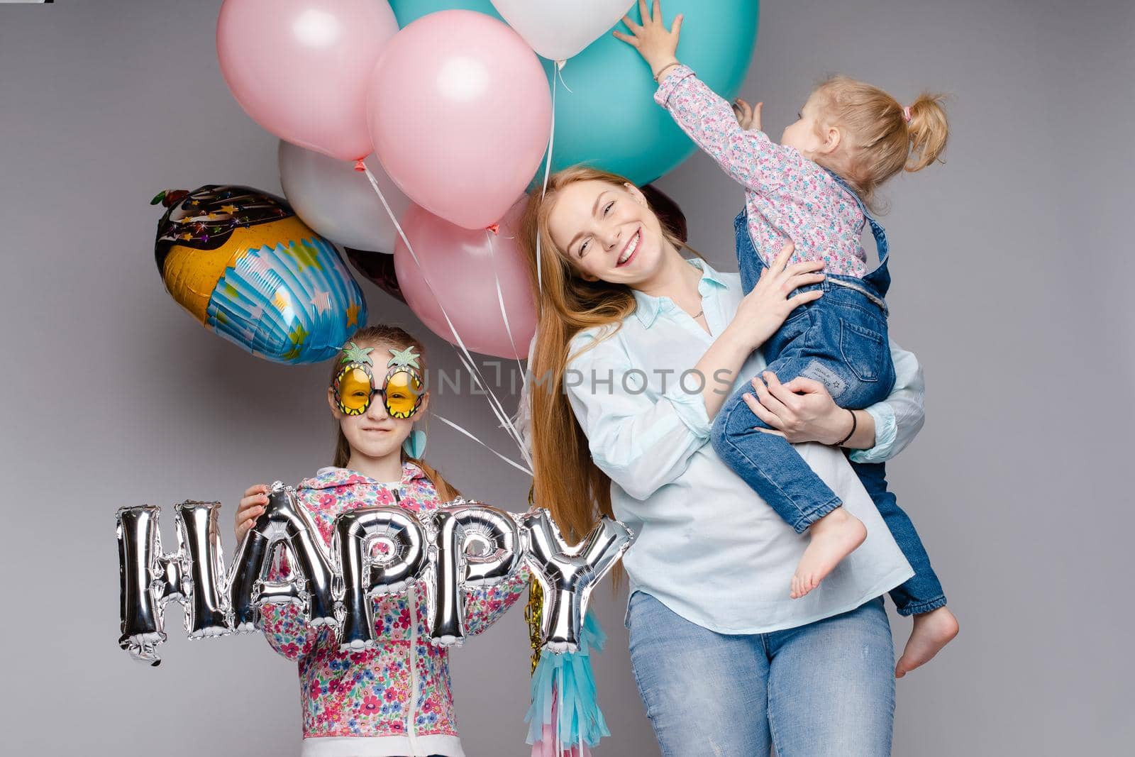Happy family posing while celebrating birthday party by StudioLucky