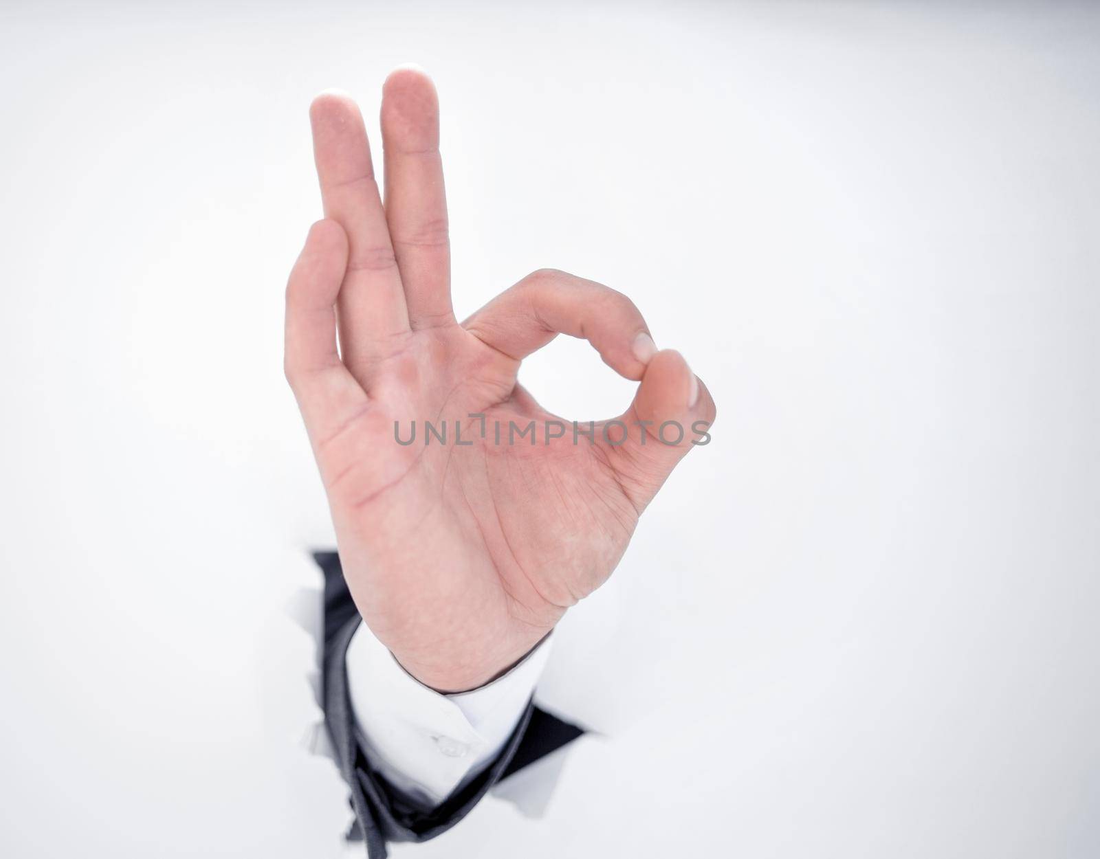 close up.hand businessman showing OK gesture.isolated on photo with copy space