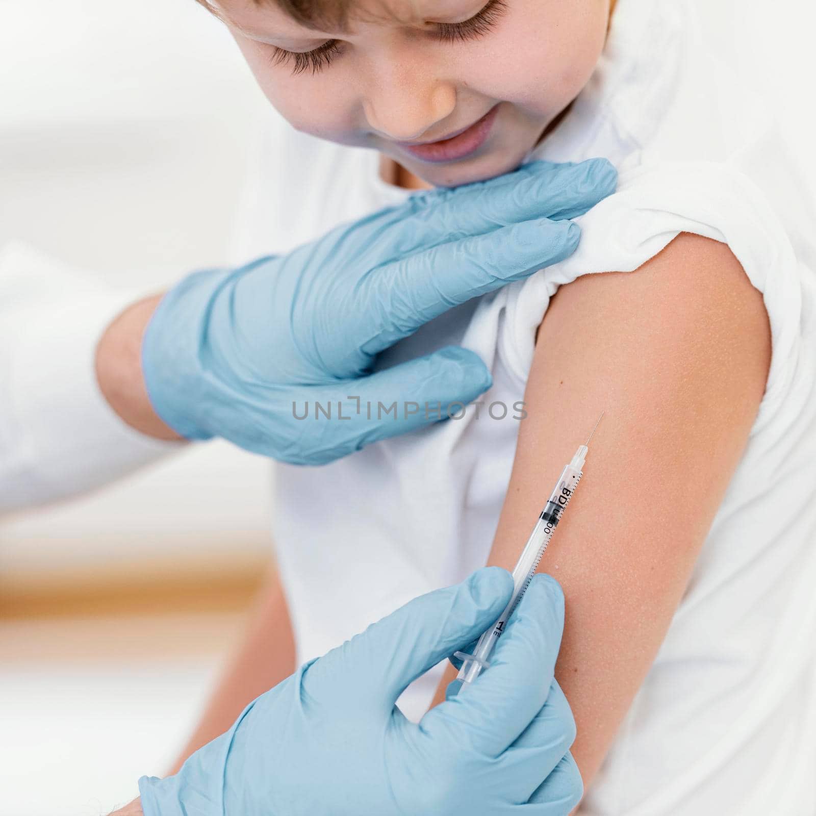 close up boy getting vaccine