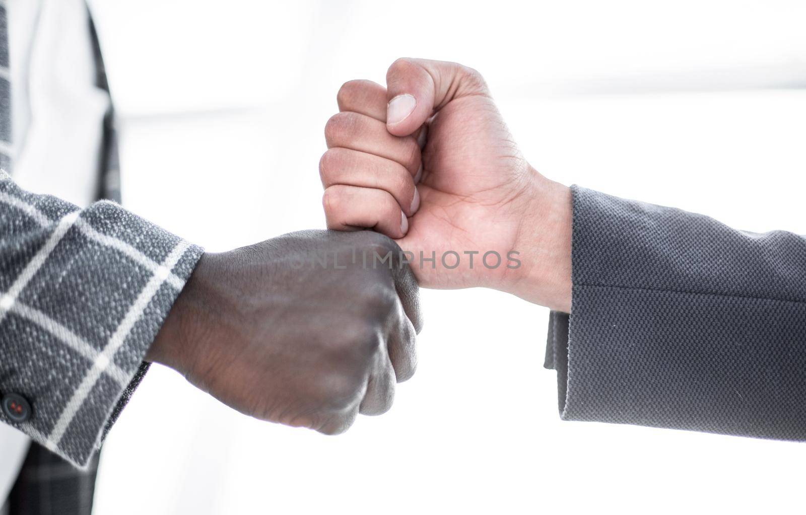 close up.two businessmen give each other a fist.concept of partnership