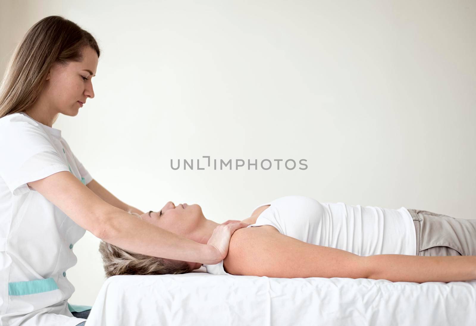 female patient undergoing therapy with physiotherapist