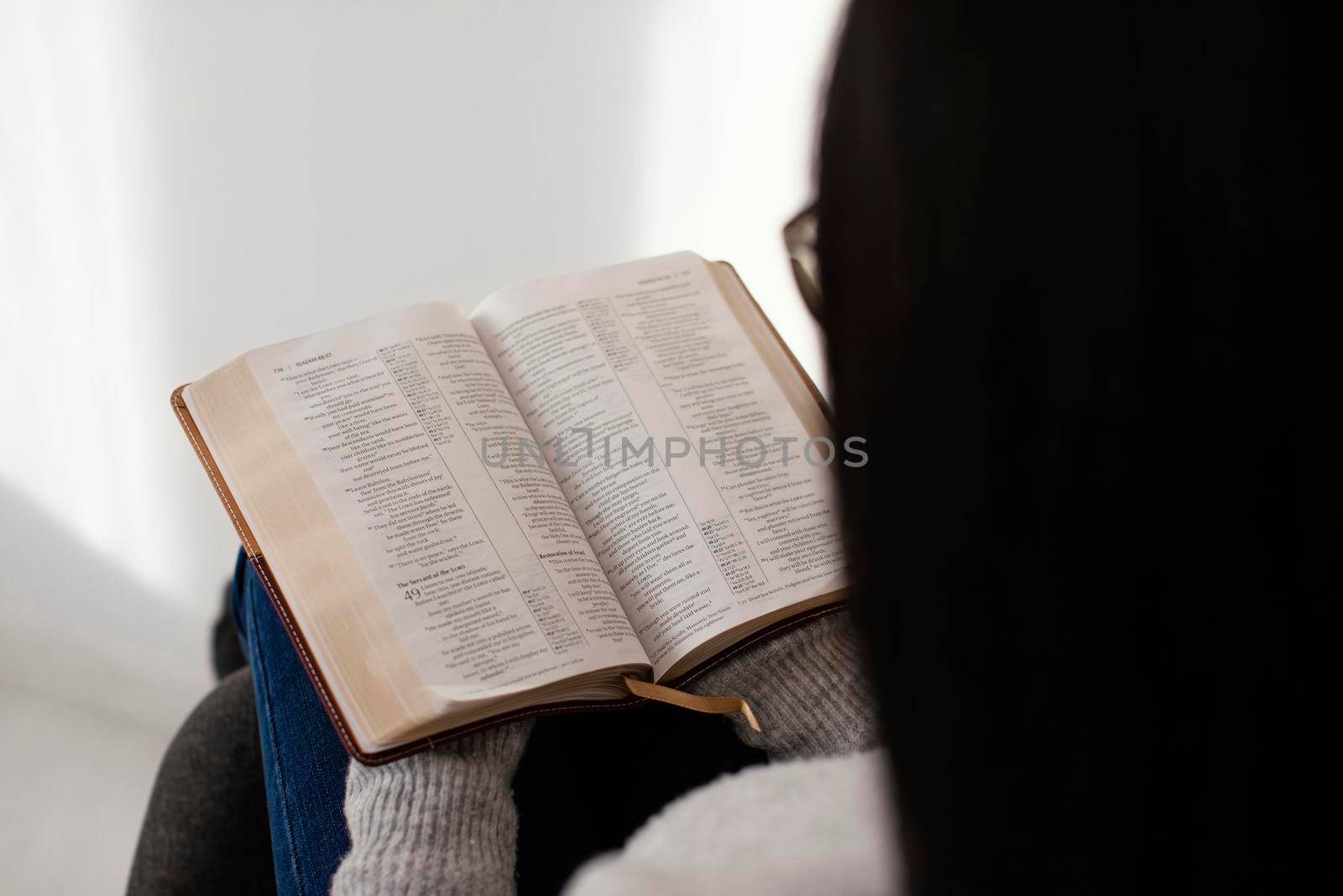 woman reading bible indoors by Zahard