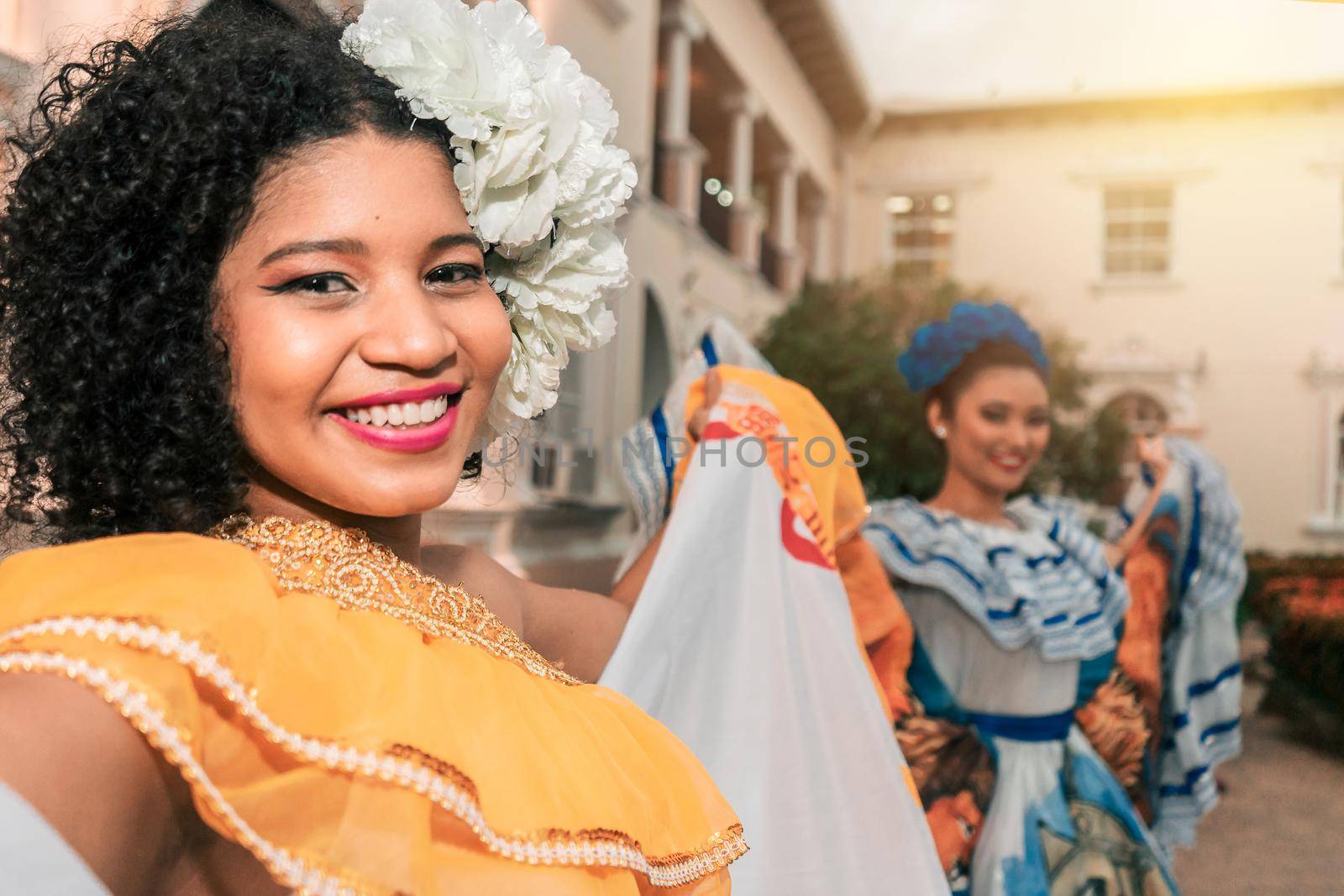 Two traditional dancers wearing the typical costume of Nicaragua smiling and looking at the camera at sunset. The dress is similar to those of other South American and Central American by cfalvarez