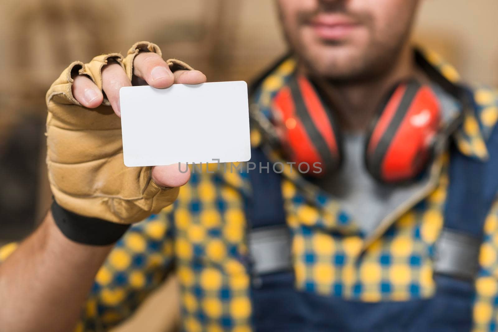 male carpenter showing blank white visiting card