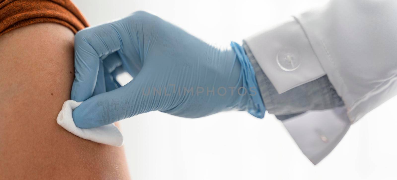 doctor putting pressure man s arm after vaccinating
