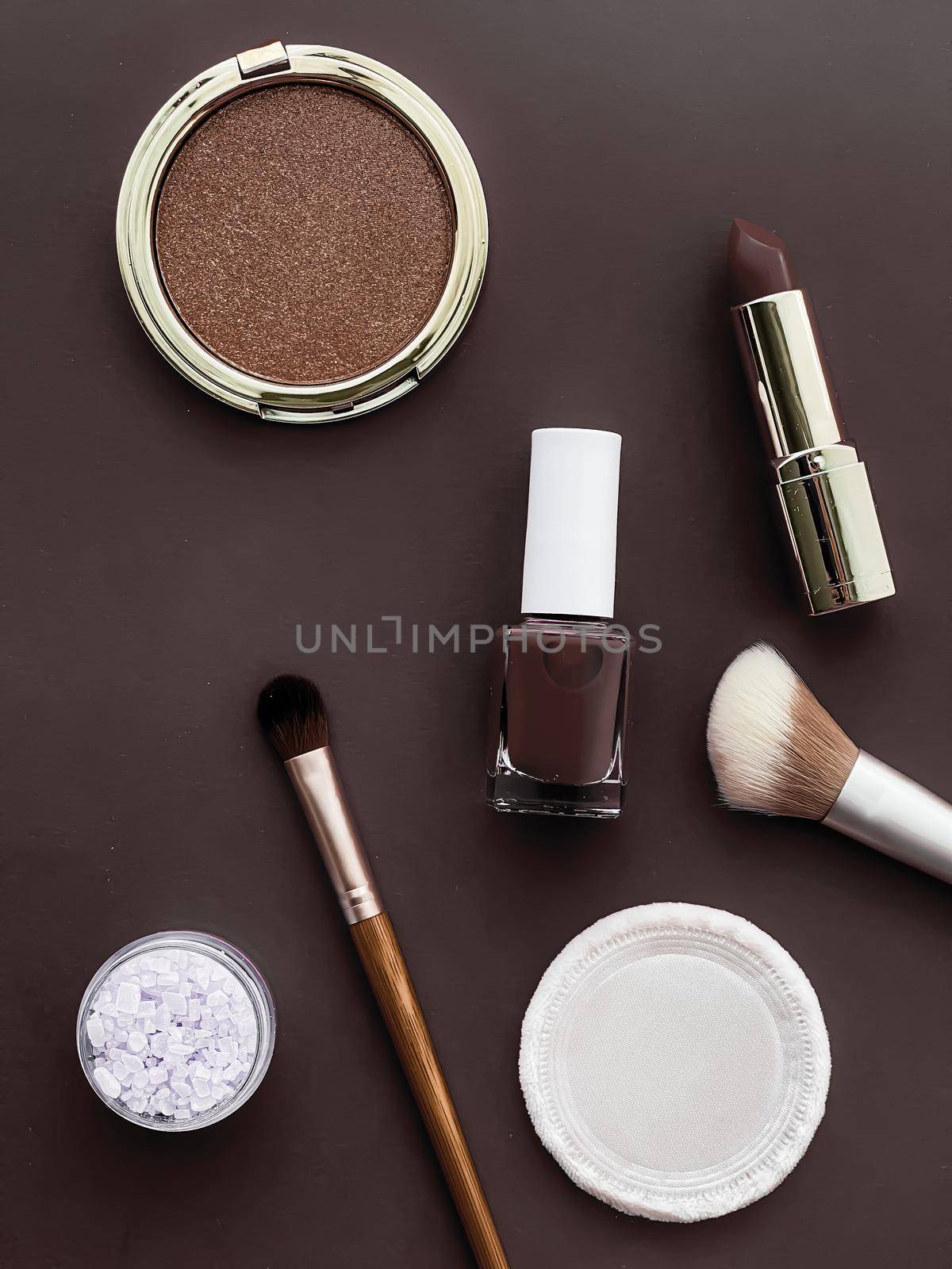 Beauty, make-up and cosmetics flatlay design with copyspace, cosmetic products and makeup tools on brown background, girly and feminine style concept