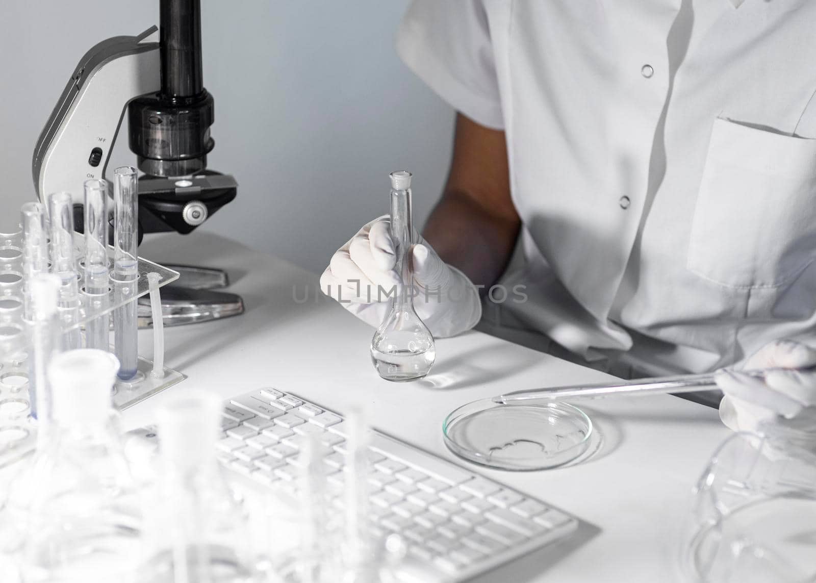 close up scientist holding glassware