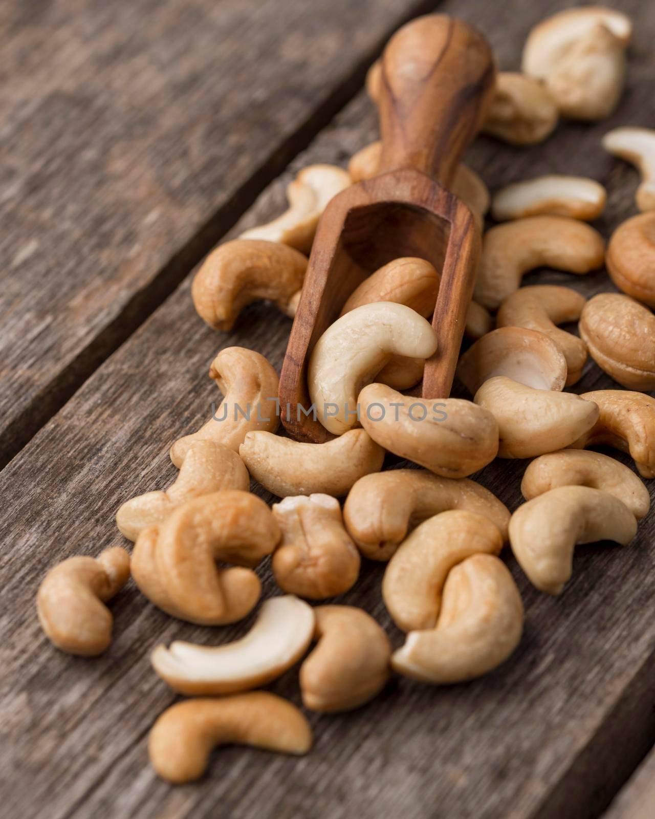 healthy raw cashew nuts small wooden spoon