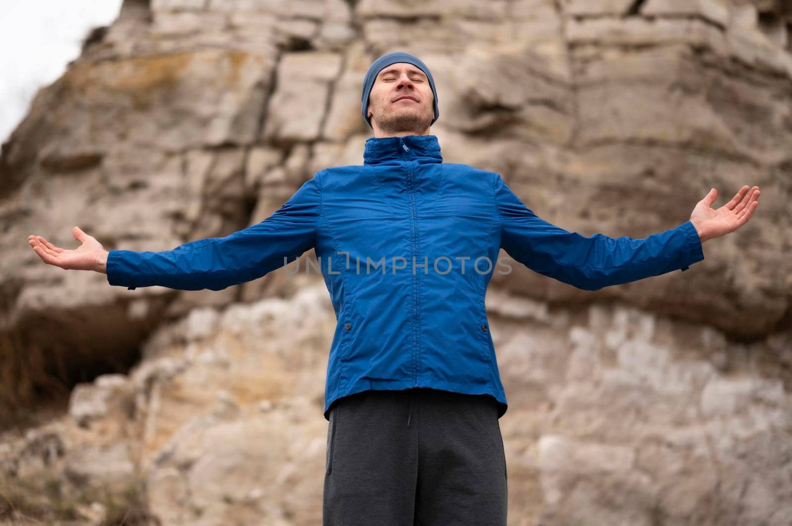 man standing nature with arms open