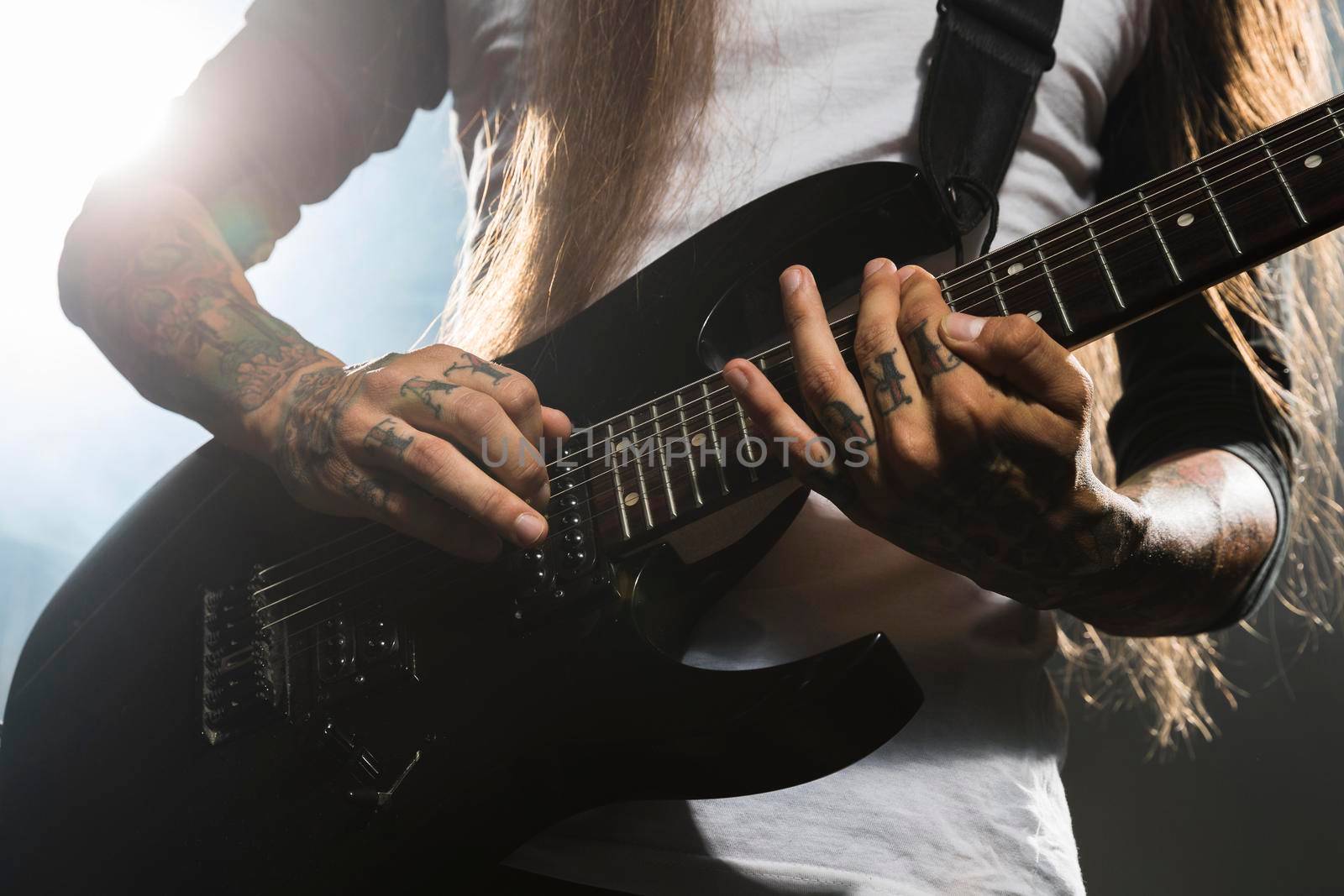 artist playing electric guitar