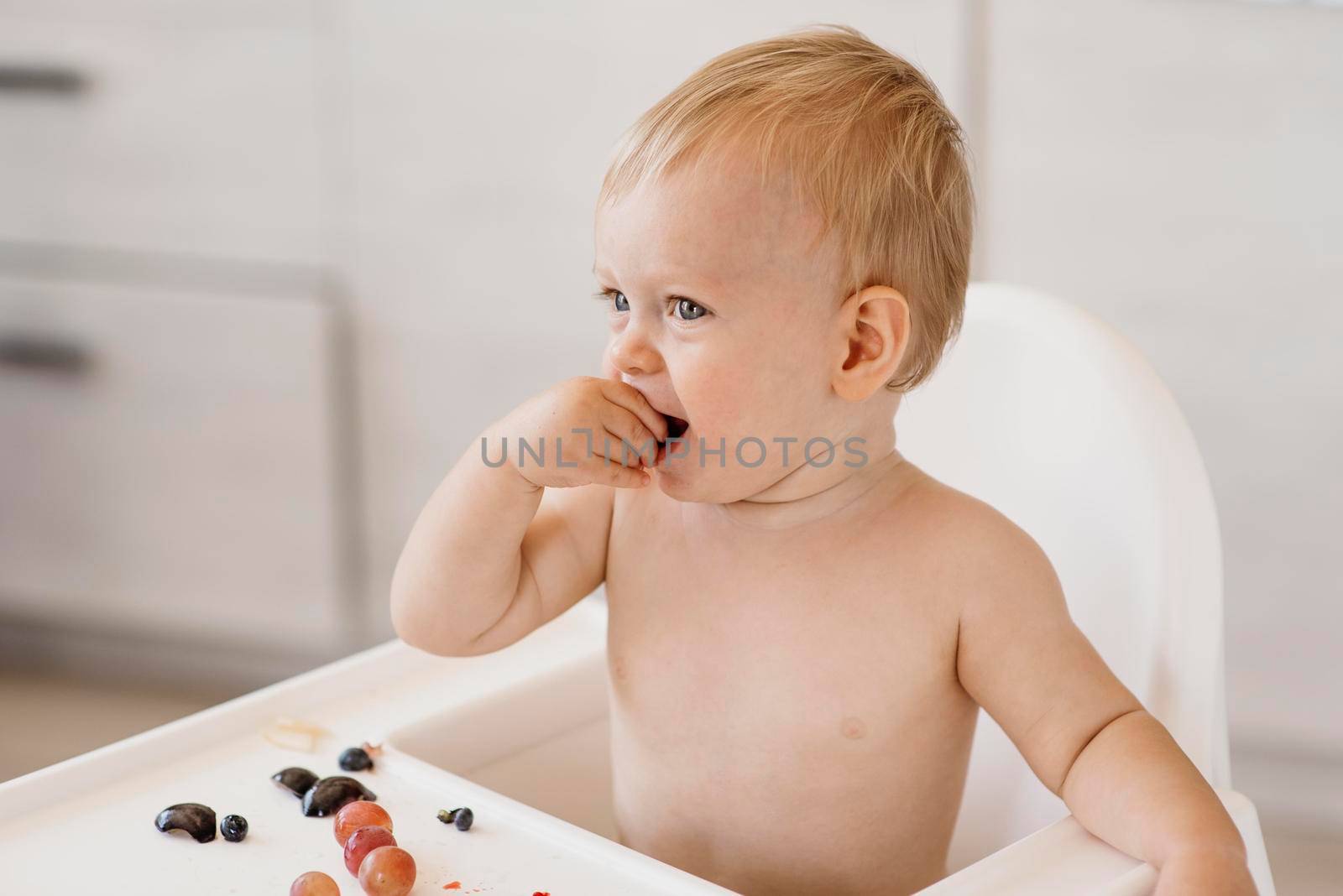 side view cute baby eating alone