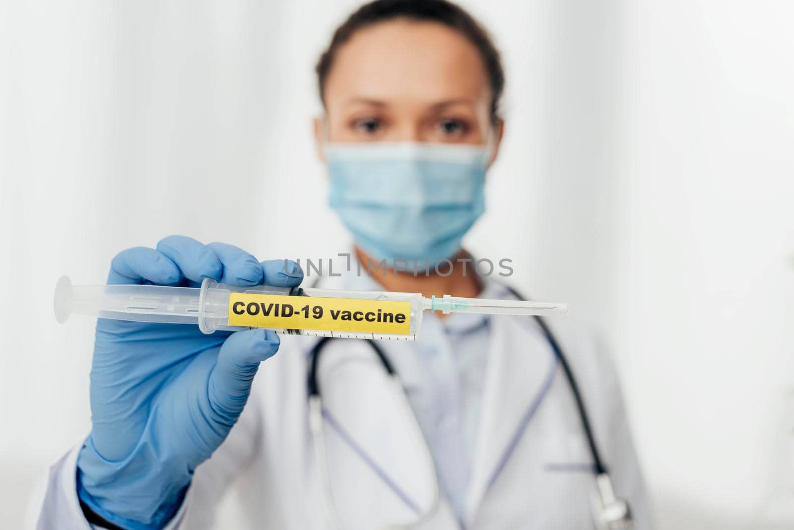 close up doctor holding covid19 vaccine by Zahard