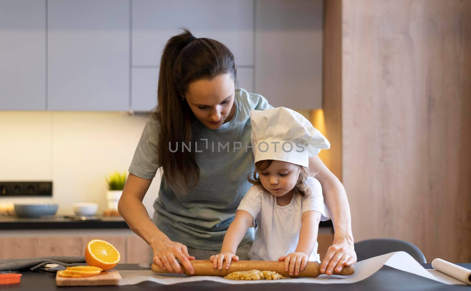 medium shot mother kid using rolling pin