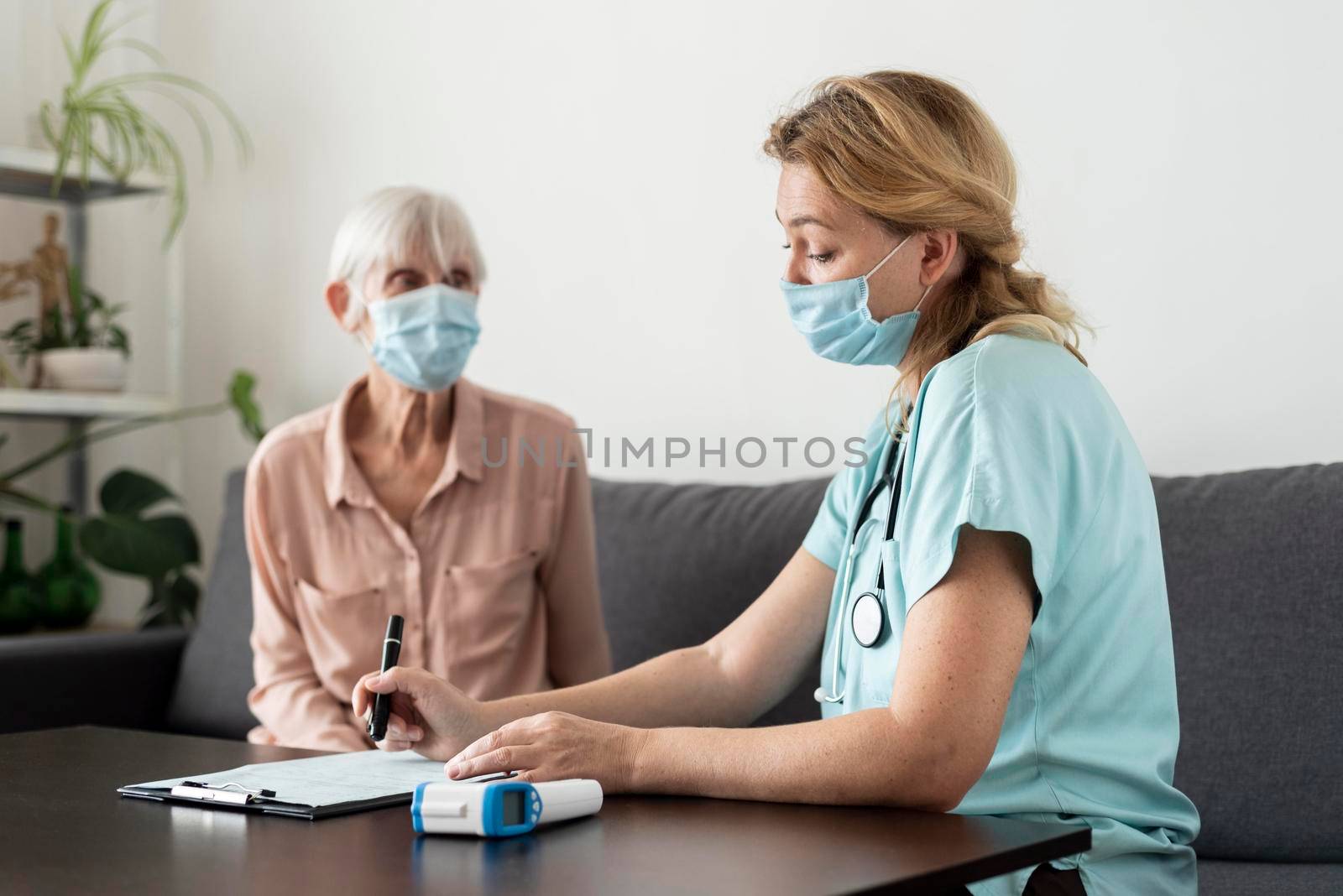 nurse senior woman during check up nursing home by Zahard