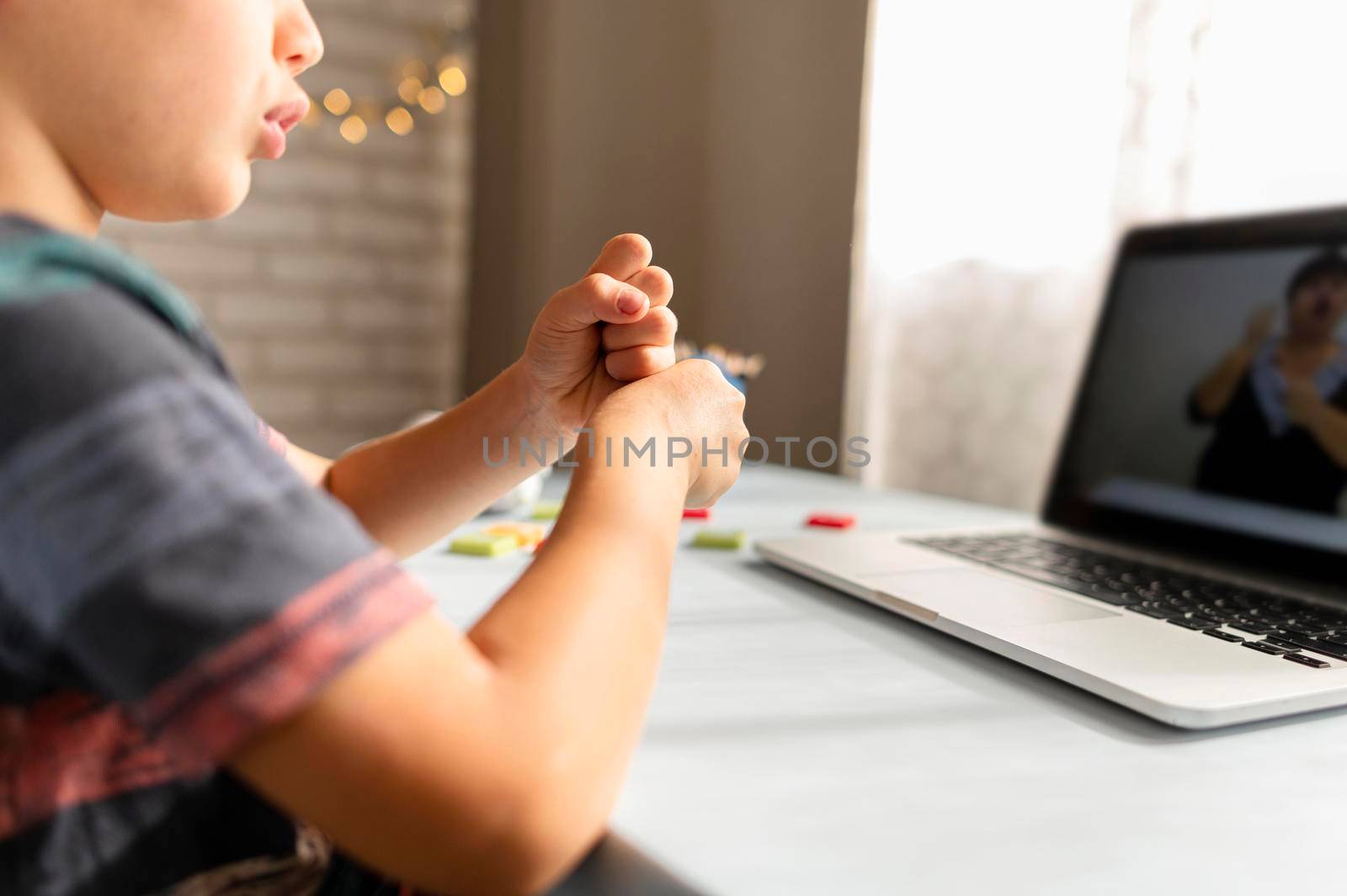 boy talking with his teacher online school