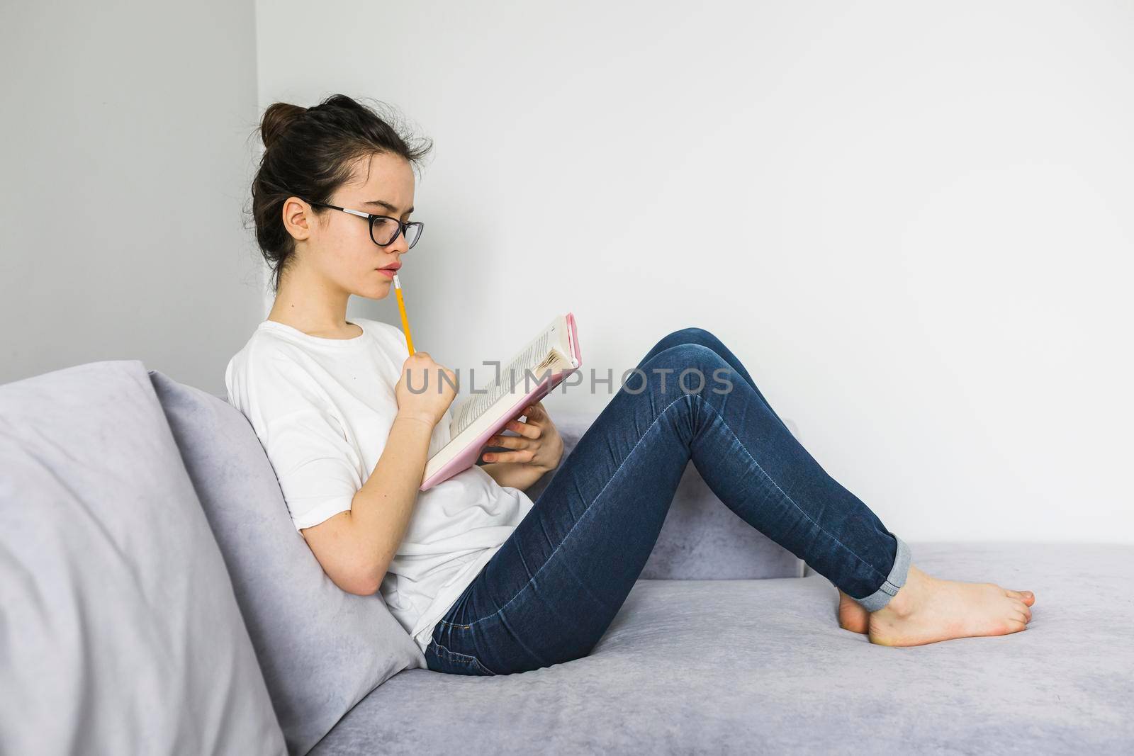 barefoot woman reading thinking by Zahard