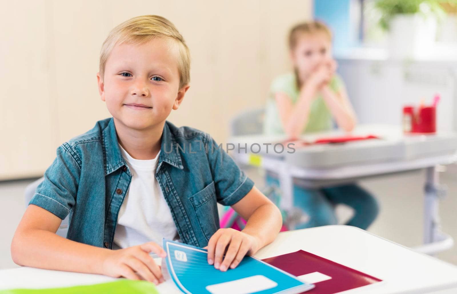 blonde kid sitting his desk by Zahard