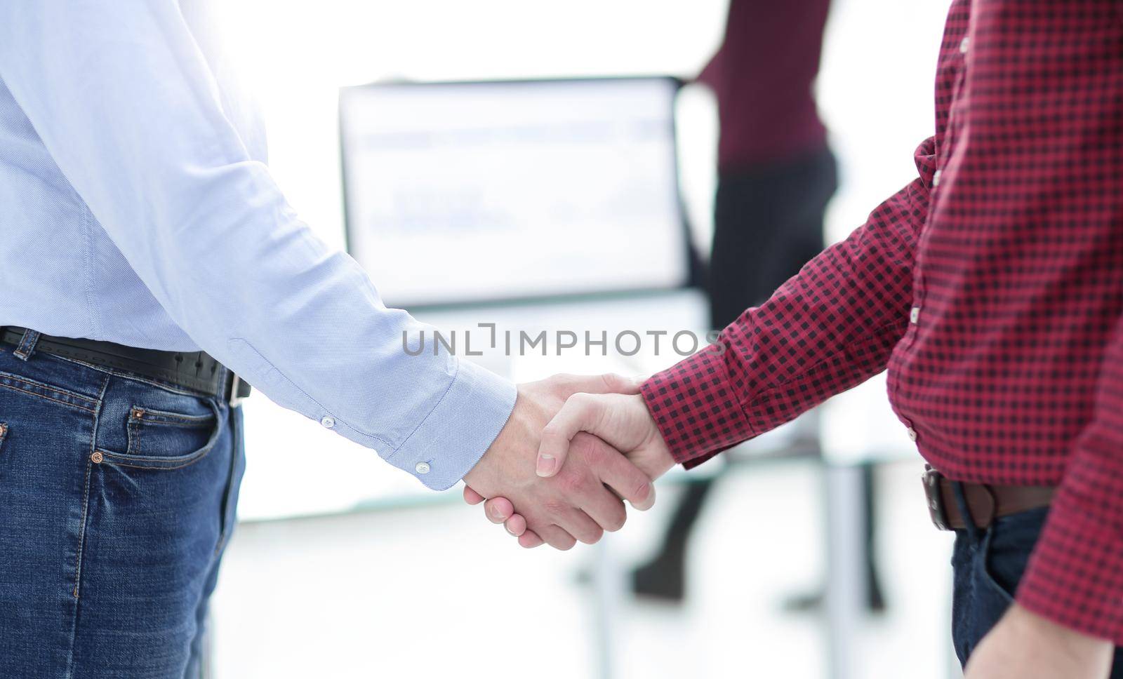 Two men handshake in the office.