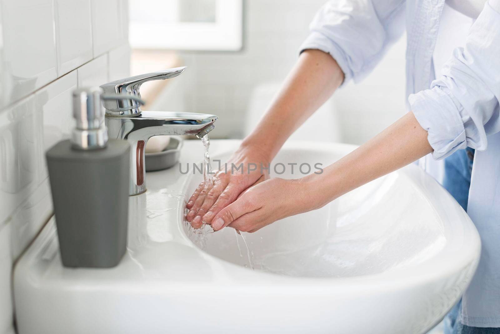 side view woman using water wash her hands by Zahard