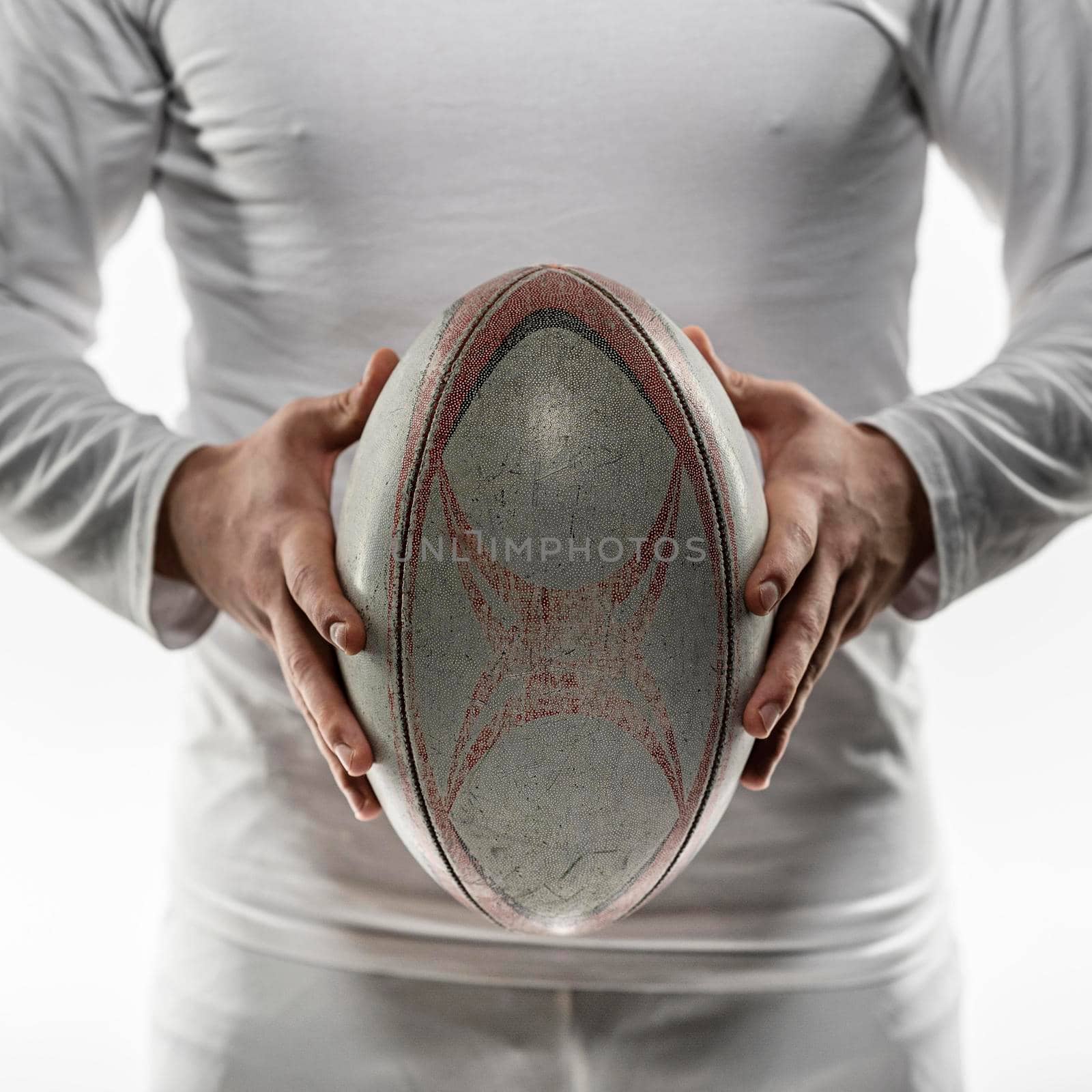 front view male rugby player holding ball with both hands by Zahard