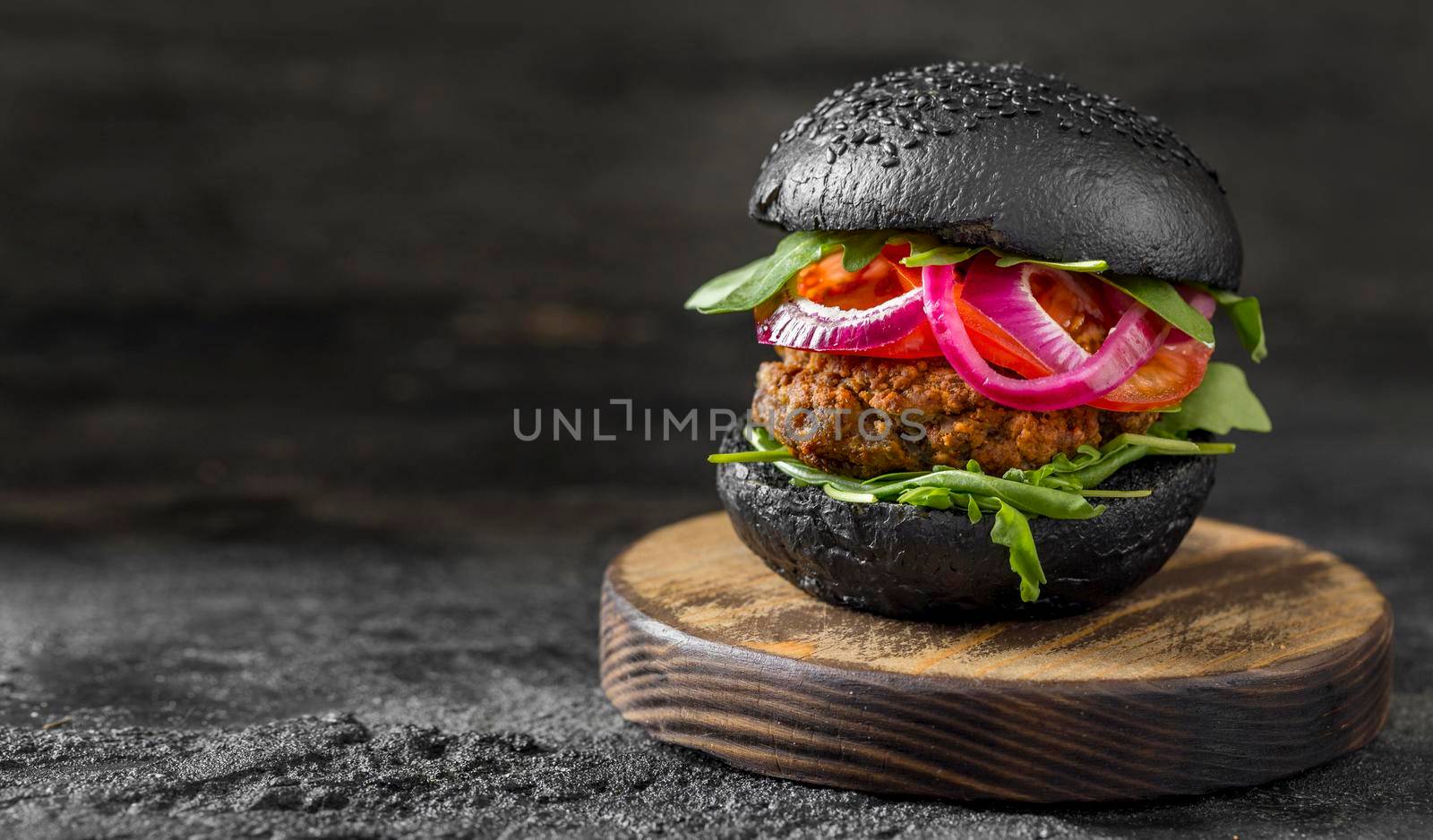 front view veggie burger with black buns cutting board by Zahard