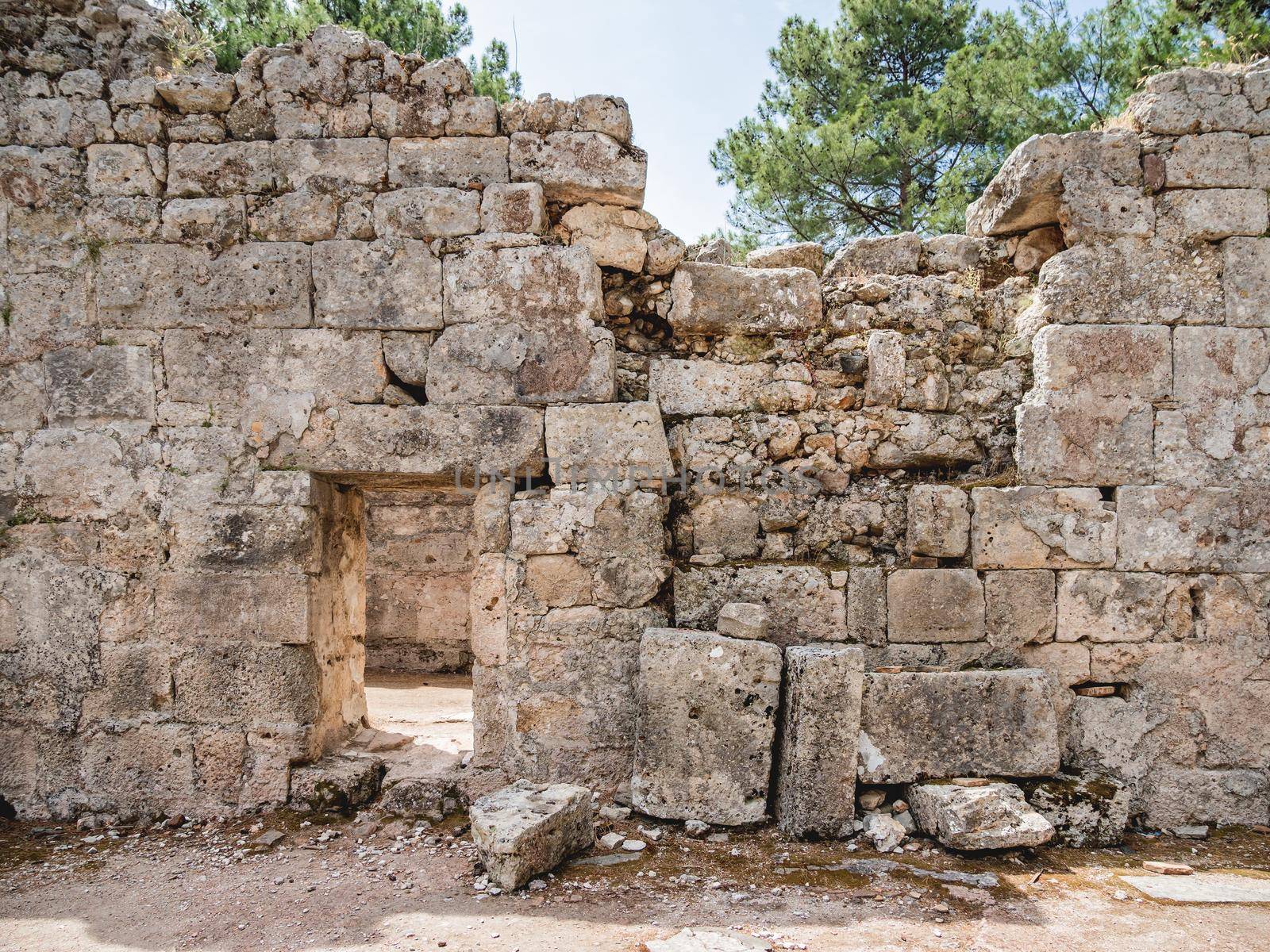 Ruins of ancient city Phaselis. Stones of damaged buildings. Architectural landmark of Turkey.