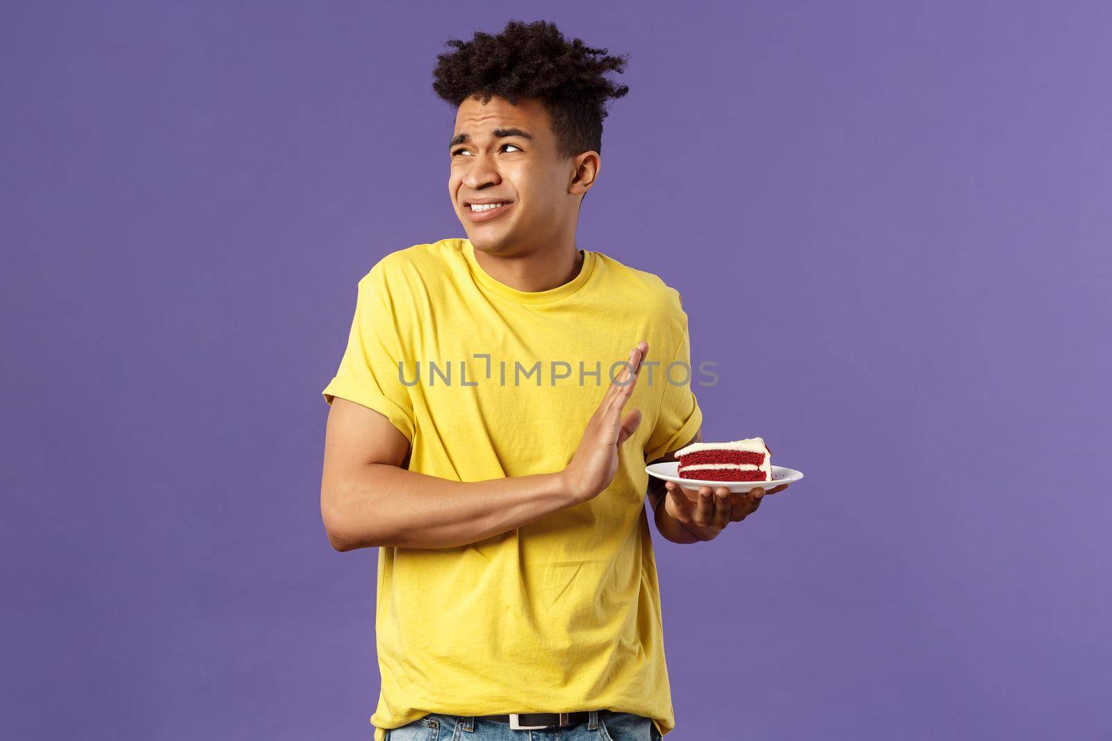 Celebration, party and holidays concept. Oh gosh its disgusting. Portrait of reluctant and displeased young man turn away from awful bad taste cake, show refusal, rejection or stop sign by Benzoix