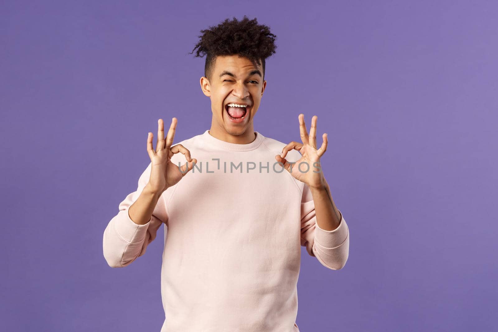 Portrait of chill young relaxed handsome man assure everything good, saying all okay, smiling and winking, recommend awesome product or online shop, leave positive feedback, purple background by Benzoix