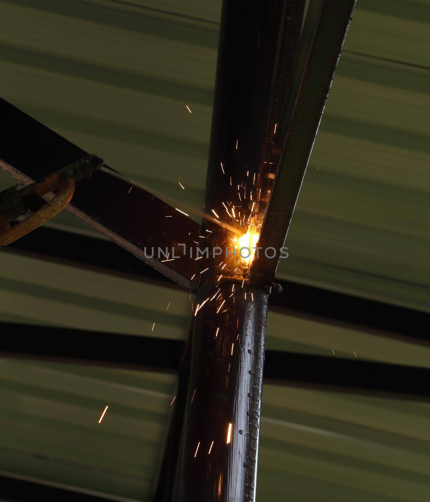 worker use electric welding connecting construction metal 