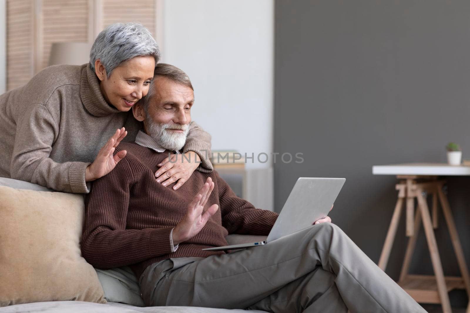 adorable senior couple video conferencing