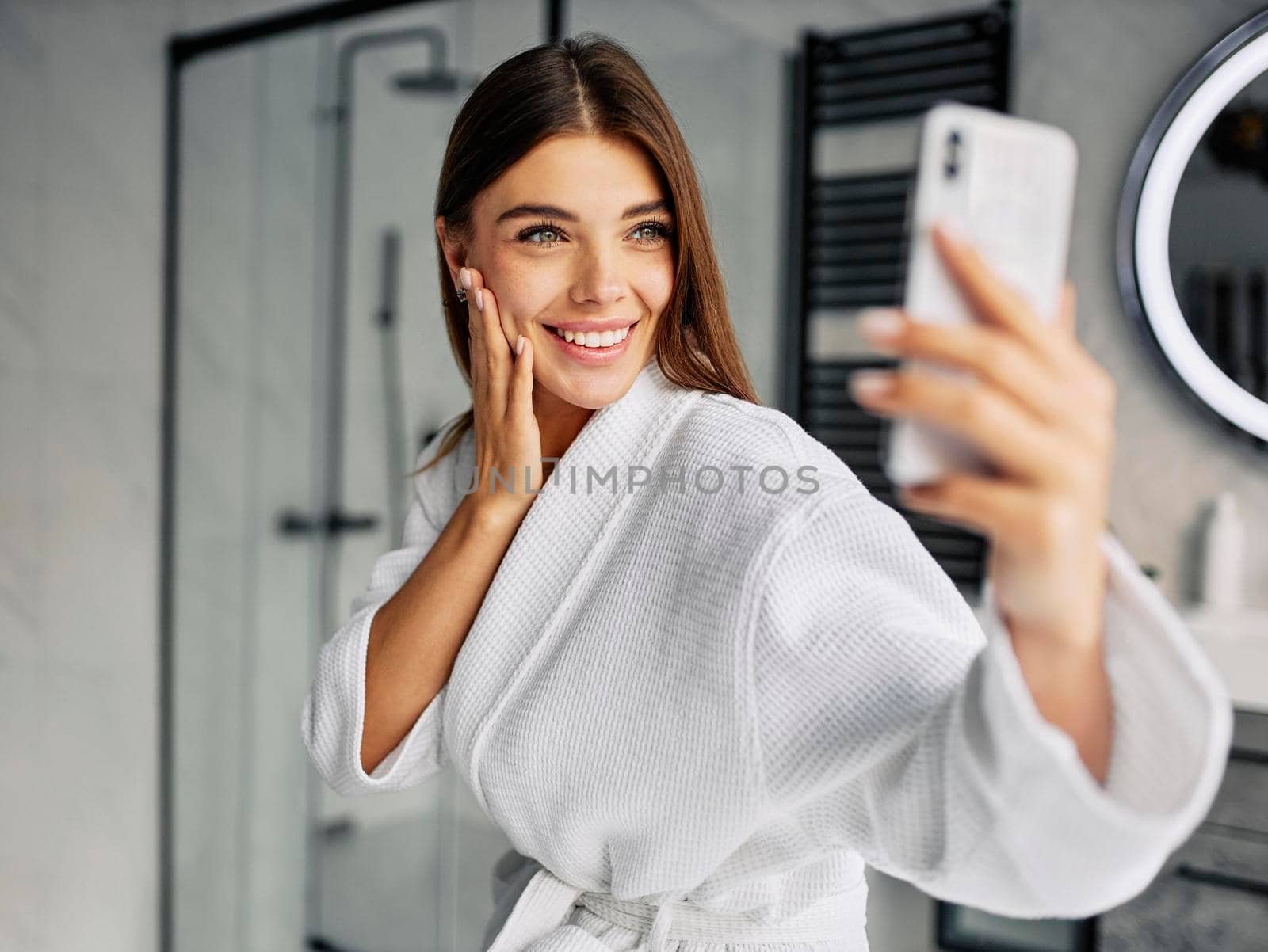 positive young woman bathrobe taking selfie by Zahard