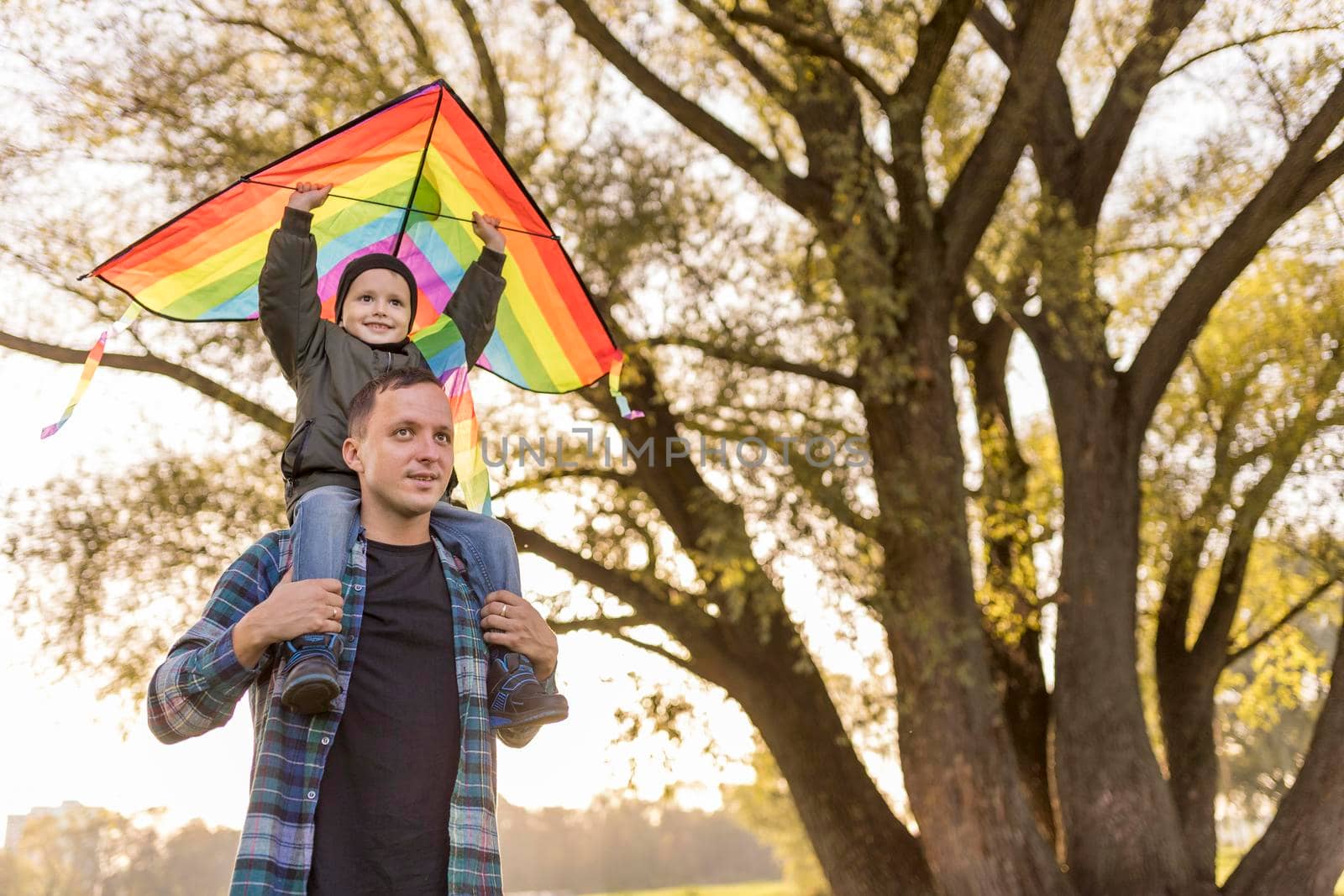 father son playing with kite